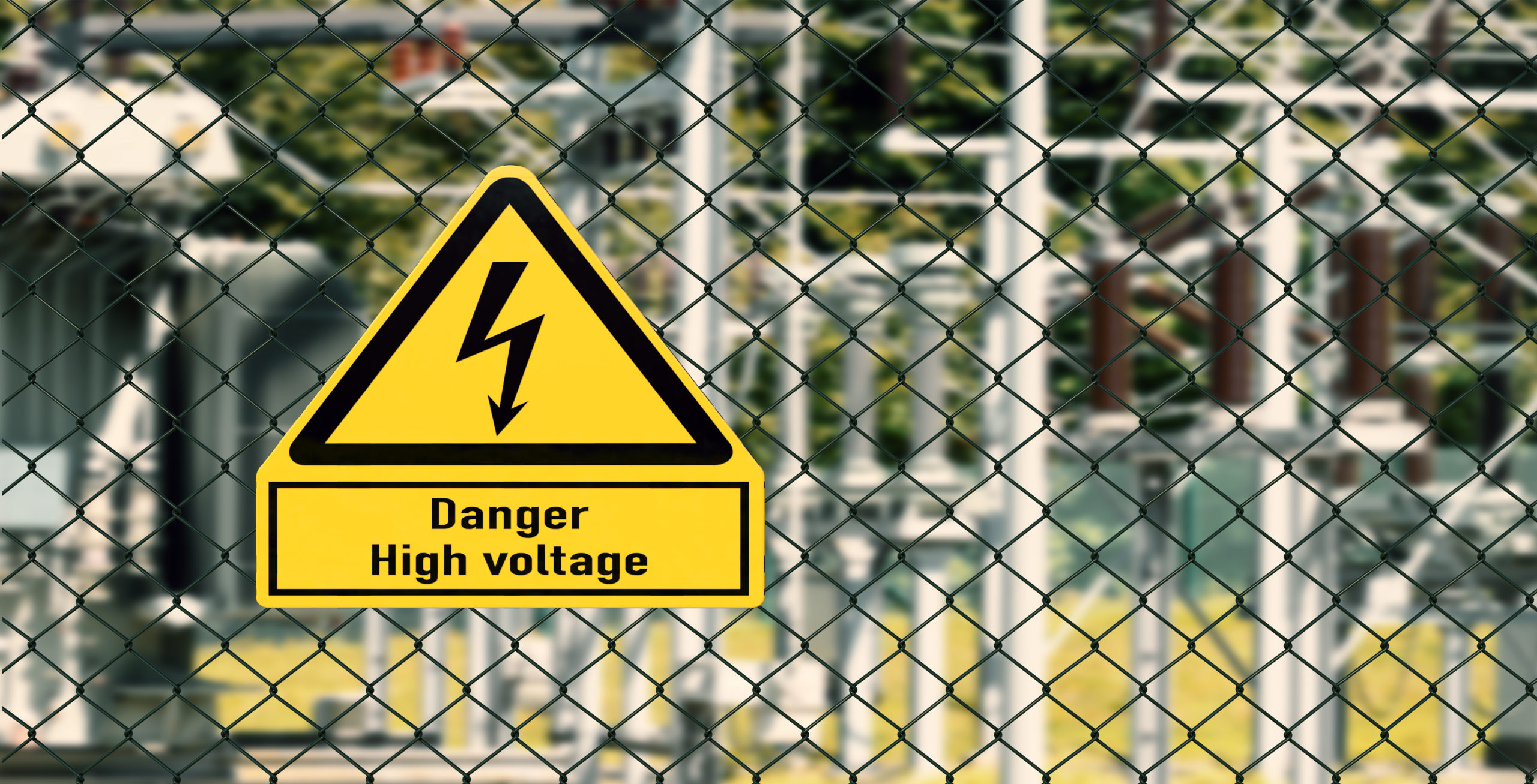 Electrical hazard sign placed on a fence of an electrical substation